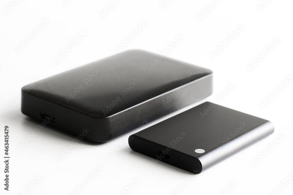 Comparison of sizes of external SSD and external HDD. Computer digital periphery. Data storage. Selective focusing Comparison of sizes of external SSD and external HDD. Computer digital periphery. Data storage. Selective focusing