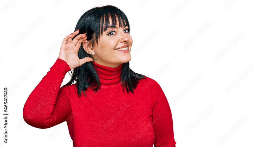 Young hispanic woman wearing casual clothes smiling with hand over ear listening an hearing to rumor or gossip. deafness concept. Young hispanic woman wearing casual clothes smiling with hand over ear listening an hearing to rumor or gossip. deafness concept.
