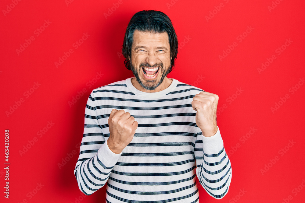 Middle age caucasian man wearing casual clothes celebrating surprised and amazed for success with arms raised and eyes closed Middle age caucasian man wearing casual clothes celebrating surprised and amazed for success with arms raised and eyes closed