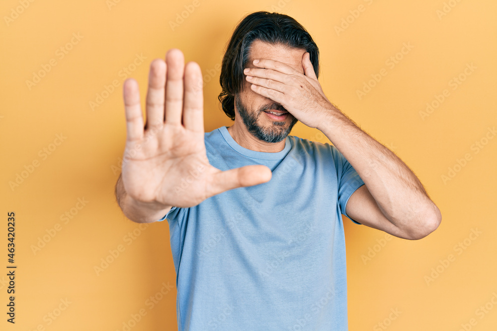 Middle age caucasian man wearing casual clothes covering eyes with hands and doing stop gesture with sad and fear expression. embarrassed and negative concept. Middle age caucasian man wearing casual clothes covering eyes with hands and doing stop gesture with sad and fear expression. embarrassed and negative concept.