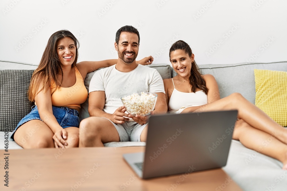 Three hispanic friends watching film using laptop home. Three hispanic friends watching film using laptop home.