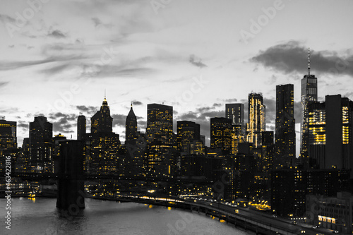 Yellow lights in black and white skyline scene of Lower Manhattan buildings in New York City
