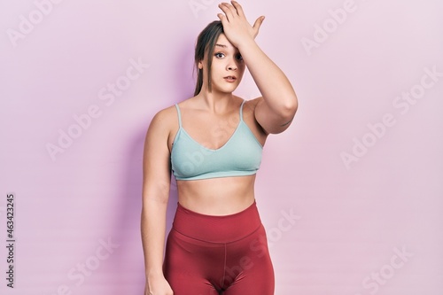 Young hispanic girl wearing sportswear surprised with hand on head for mistake, remember error. forgot, bad memory concept. © Krakenimages.com