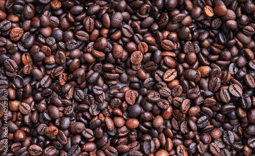 Brown and black coffee beans. Roasted arabic espresso coffee grains.