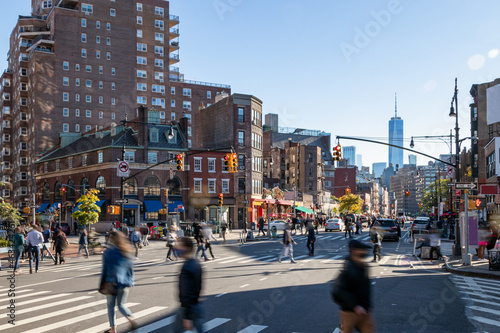 Crowds of people walking across a busy intersection on 7th Avenue in New York City