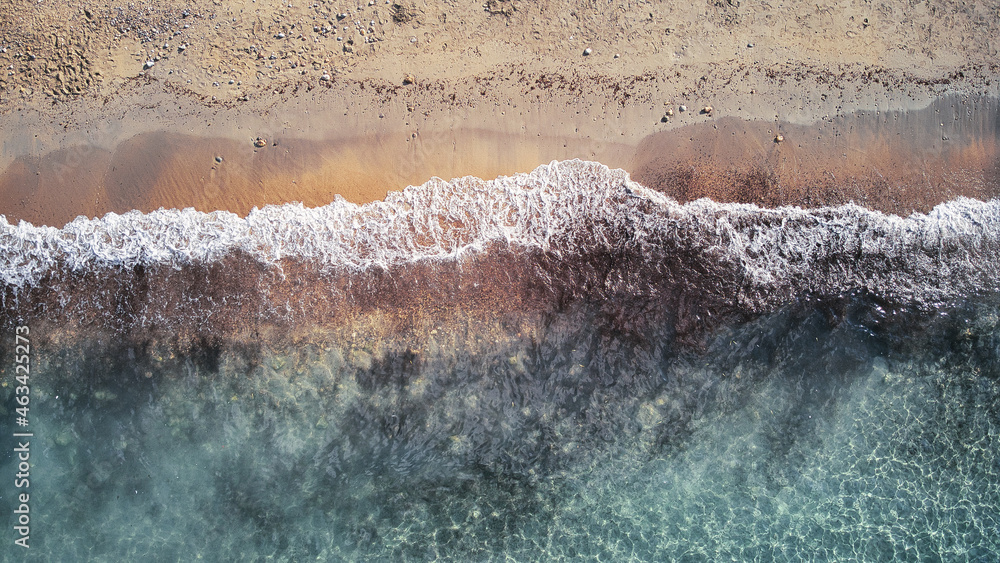 Beautiful birdsview with a drone on the beach, sand, sea and waves.