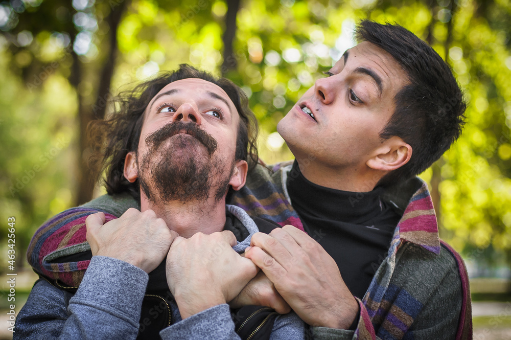 Fototapeta premium Young gay homosexual couple in physical confrontation and a fight