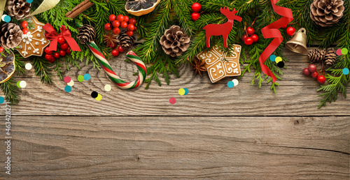 Fir tree branches and christmas decorations on wooden background.
