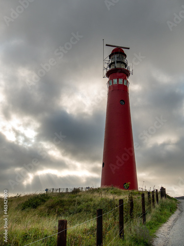 Red Lighthouse at Schiermonnikoog. Noordertoren. with beautiful scenery  lights and heavy sky in the dunes 