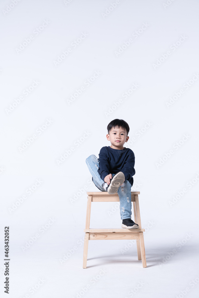Asian boy wearing shoes by himself