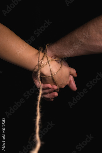 The bound hand of a man and a woman