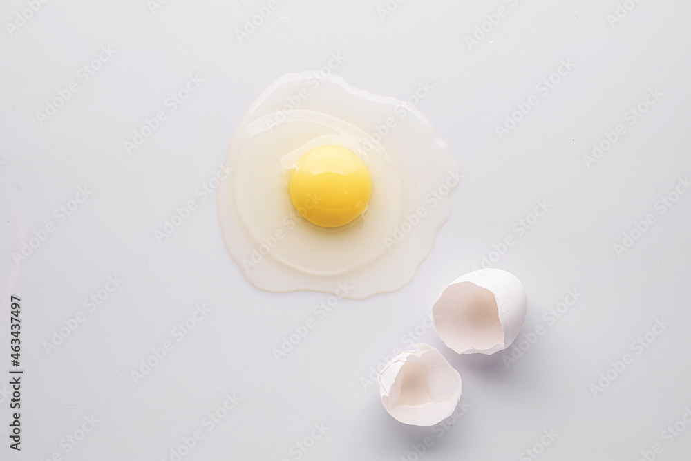 broken egg and shell on a white background, flat lay broken egg and shell on a white background, flat lay