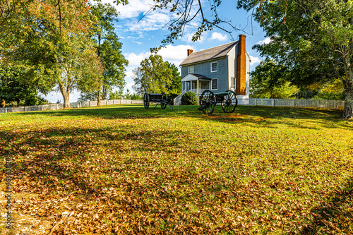 Civil War cannons at an old house in Appomattox Court House in the fall photo