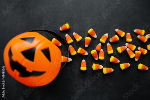 Halloween Background. Candy corn candies, pumpkin basket. Traditional sweet Treats. Copy space photo