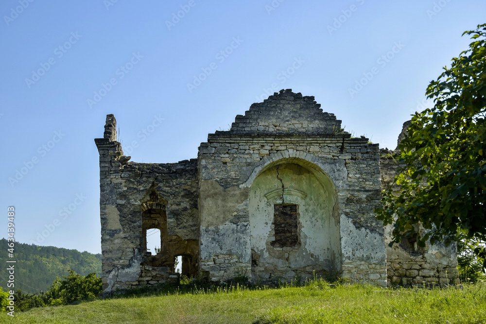 Ruins of an ancient Christian temple on background of blue sky with clouds. Old dilapidated church. Copy space. Selective focus.