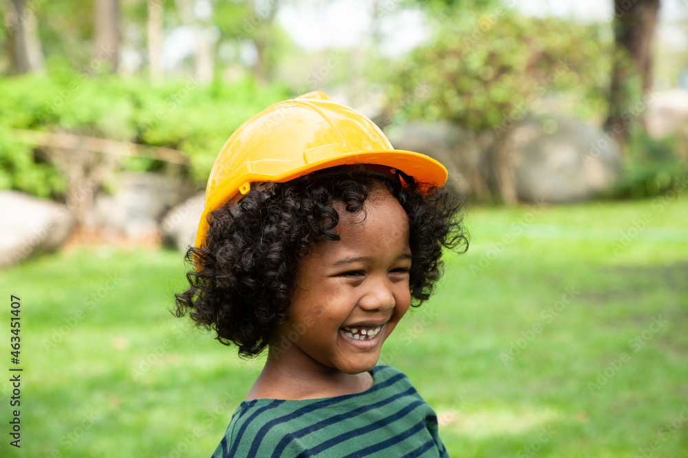 Portrait of African American boy wearing safety hat playing in the park with happy and smile Portrait of African American boy wearing safety hat playing in the park with happy and smile