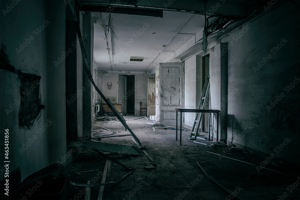 Scary empty dark corridor in an abandoned building. Shabby walls. The play of light and shadows in an abandoned house. Broken doors. An old abandoned hospital. The interior of an abandoned house. Scary empty dark corridor in an abandoned building. Shabby walls. The play of light and shadows in an abandoned house. Broken doors. An old abandoned hospital. The interior of an abandoned house.