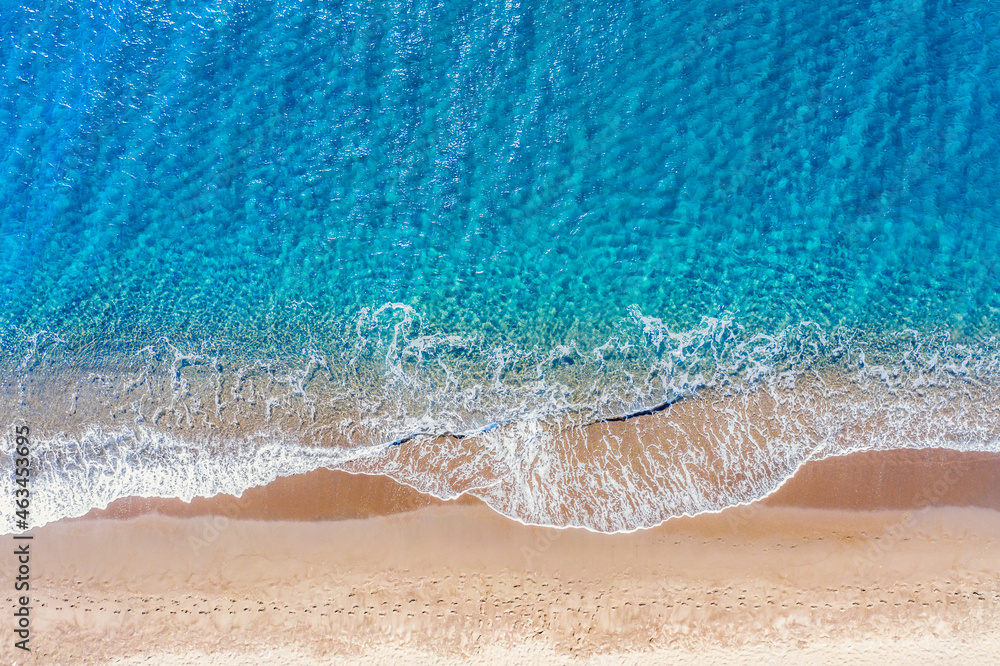 Top view aerial drone photo of Perissa beach with beautiful turquoise water and sea waves. Vacation travel background. Aegean sea, Santorini Island, Greece Top view aerial drone photo of Perissa beach with beautiful turquoise water and sea waves. Vacation travel background. Aegean sea, Santorini Island, Greece