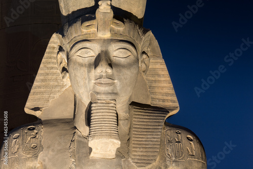 The statue of Ramesses II Illuminated at night in the temple of Luxor photo