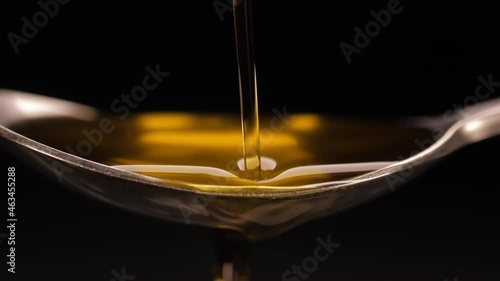 pouring olive oil into spoon slow motion