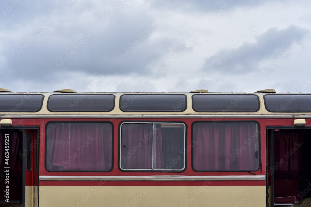 vintage bus with panoramic roof with windows in rainy day