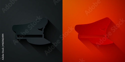 Paper cut Pilot hat icon isolated on black and red background. Paper art style. Vector