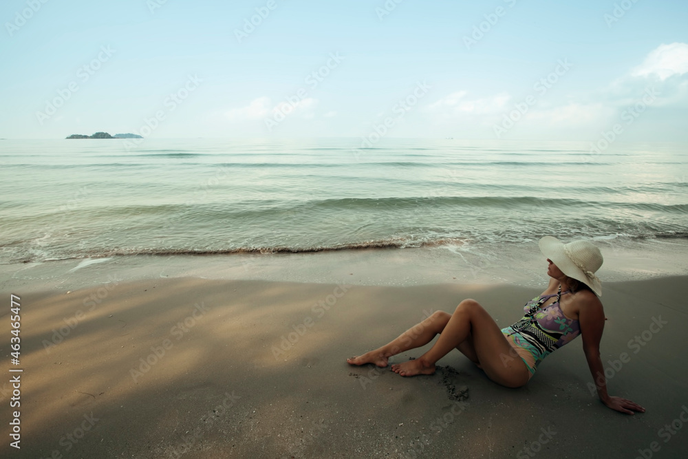 A young woman is resting on the sea tropical beach. A young woman is resting on the sea tropical beach.