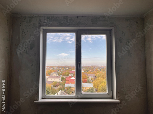 Old room and window from a tree in the room with the repair. View of the autumn season