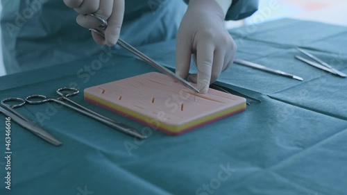 Education concept of 4k Resolution. A doctor is practicing sutures with a practice apparatus. photo