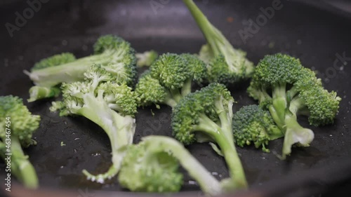 frying broccoli on oil fry pan slow motion photo