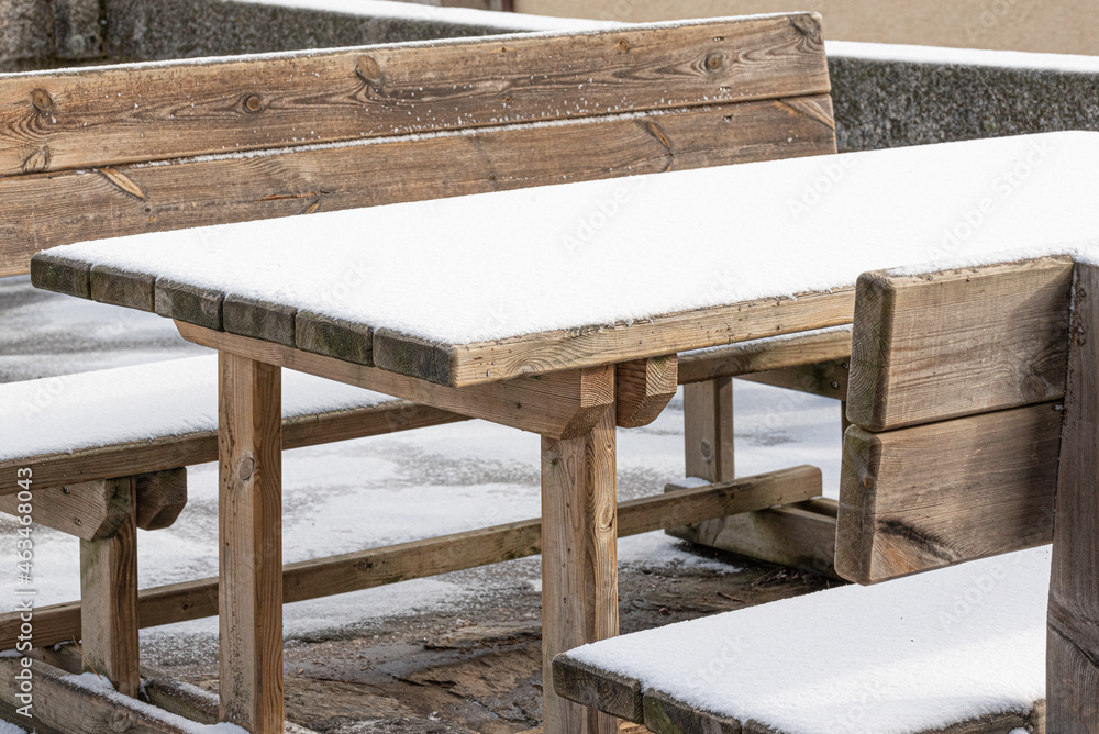 Fototapeta premium Wooden table with benches snowed in winter