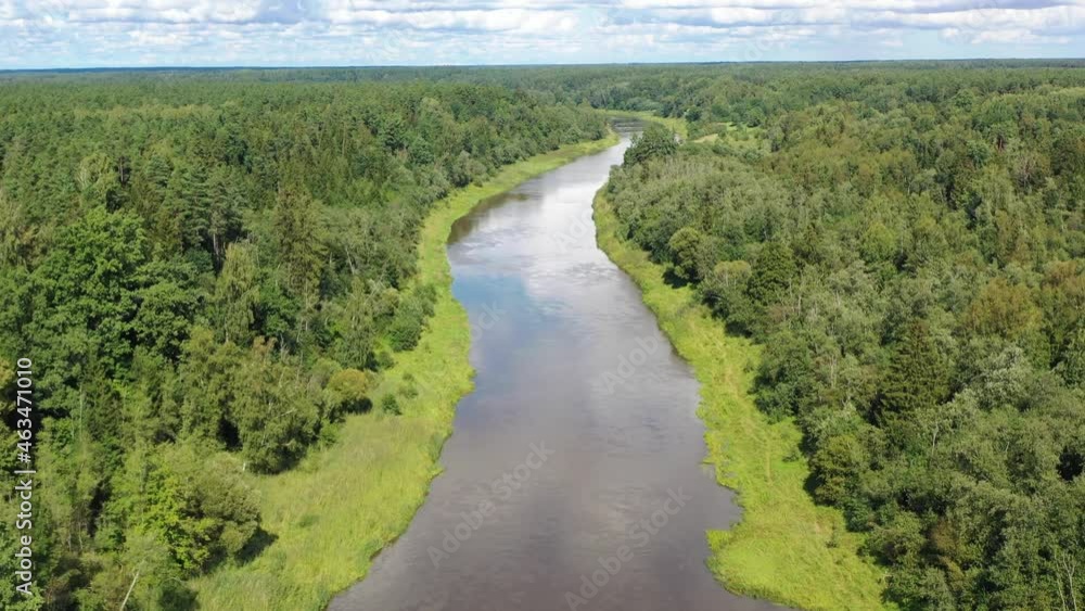 Aerial shot flying along river. River sorrounded by green forest Aerial shot flying along river. River sorrounded by green forest