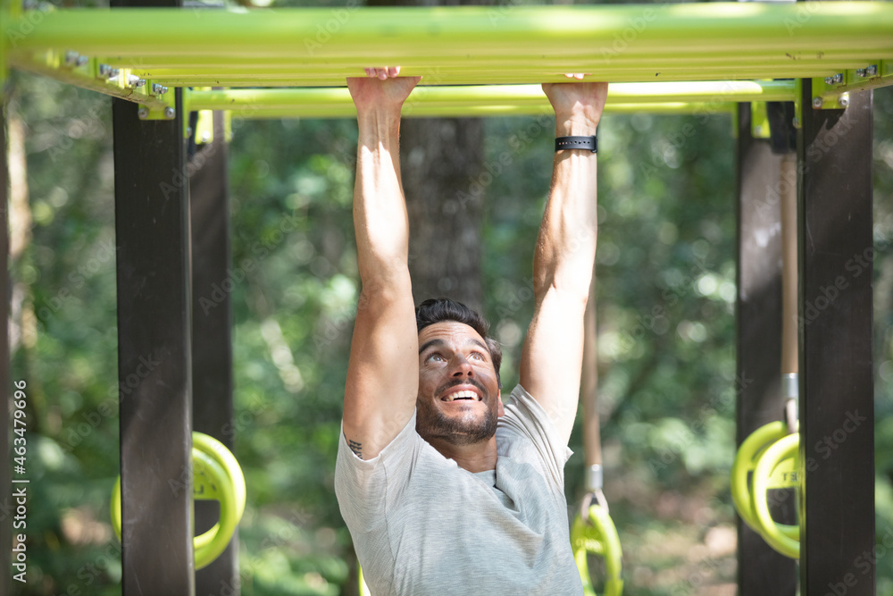Fototapeta premium exercise fitness athlete exercising on monkey bars