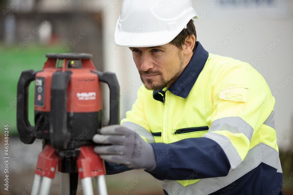 surveyor setting up theodolite equipment