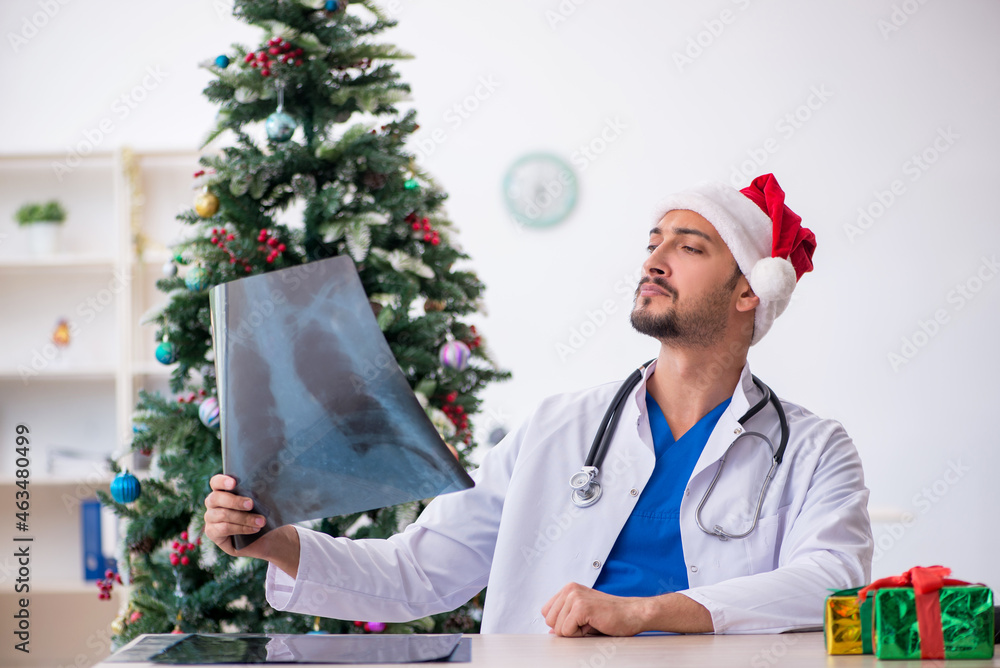 Young male doctor celebrating Christmas at the hospital Young male doctor celebrating Christmas at the hospital
