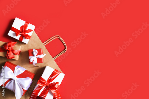 Boxes with ribbons on a red background.Present..Beautiful boxes with gifts. Shopping.