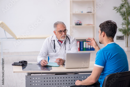 Young male patient visiting old male doctor