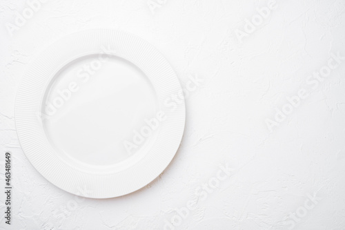 Ceramic empty white plate with copy space for text or food with copy space for text or food, top view flat lay , on white stone table background
