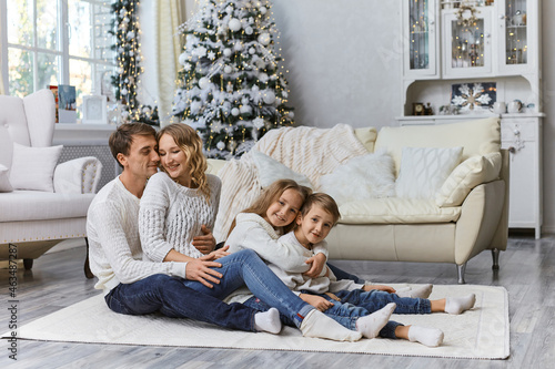 Shot of happy young family sitting on the floor