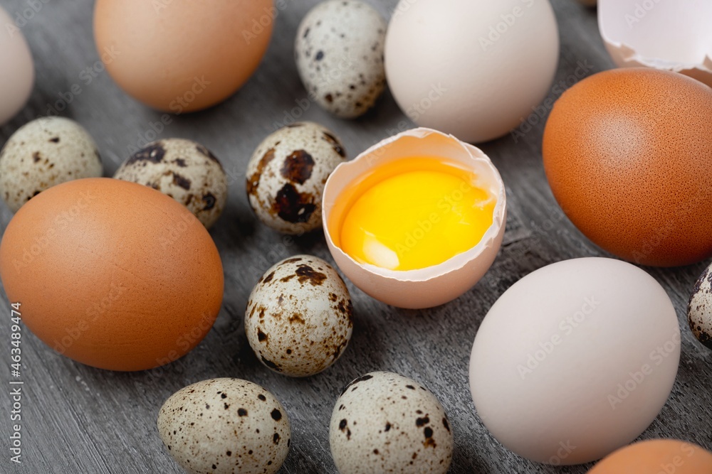 Top view of chicken and quail eggs on table Top view of chicken and quail eggs on table