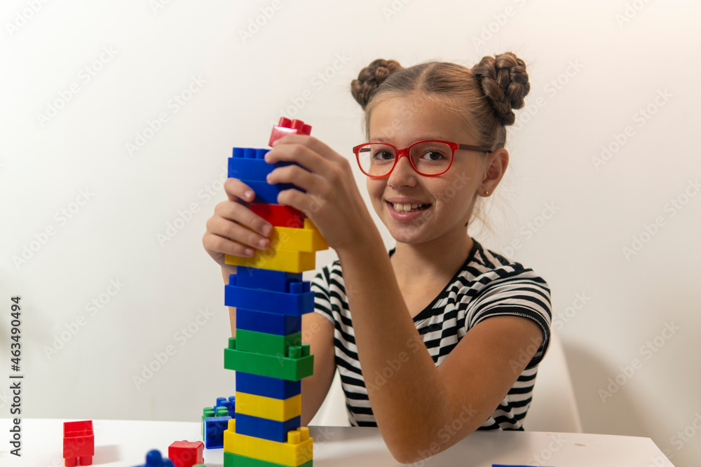 Girl with creative toys. Child on a white background. the concept of the development of fine motor skills of children