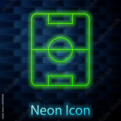 Glowing neon line Football or soccer field icon isolated on brick wall background. Vector