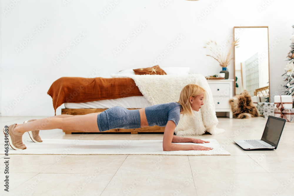 Young woman doing the plank exercise at home Young woman doing the plank exercise at home