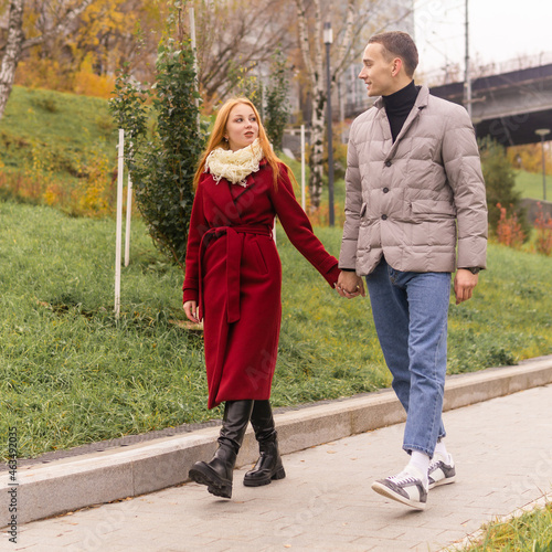young couple walking in the autumn park
