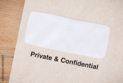 Private and confidential business envelope on desk, UK