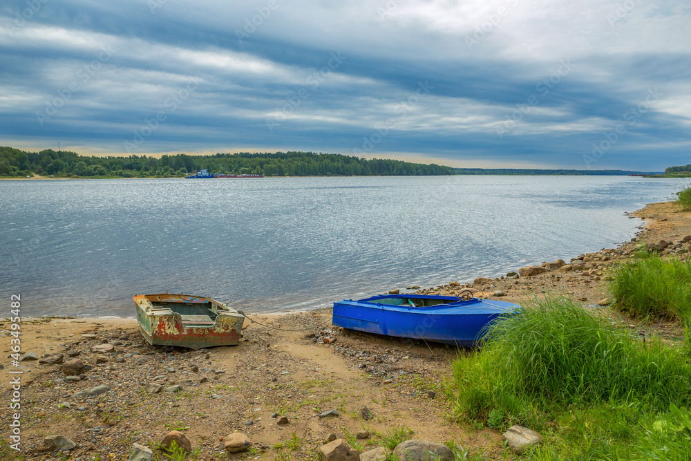 Old boats on the river bank. Russia, Volga river