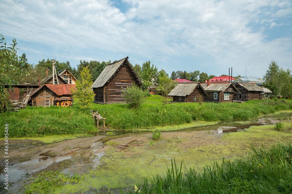 Old wooden houses in the summer village. Russia