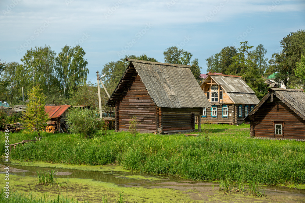Old wooden houses in the summer village. Russia