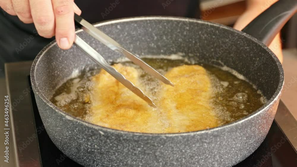 Fry 2 schnitzel in a pan with clarified butter. The cook turns the cutlets so that they are browned on both sides. Fry 2 schnitzel in a pan with clarified butter. The cook turns the cutlets so that they are browned on both sides.