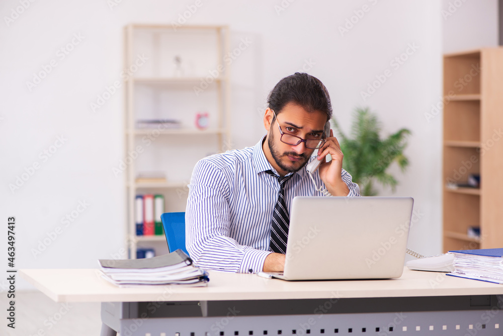 Young male employee working in the office Young male employee working in the office